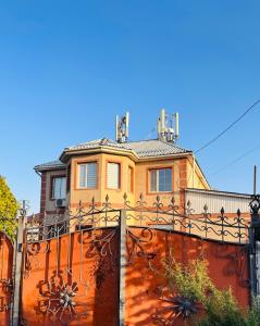 a house sitting on top of a fence at Cottage Лома city center 7 to 2 floor in Taldykorgan