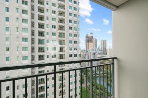 a balcony with a view of a tall building at Javen by Kozystay - Thamrin in Jakarta