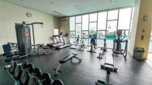 a gym with several treadmills and machines in it at Javen by Kozystay - Thamrin in Jakarta