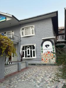 a building with a mural on the side of it at Ta Hayatt in Srinagar