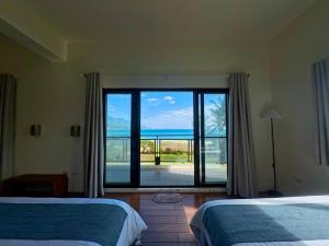 Postel nebo postele na pokoji v ubytování 月伴灣海景民宿MoonBay Seaview Homestay - 半自動入住 Self check-in