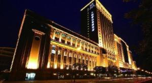 a large building with lights on it at night at Teda Dalian in Dalian