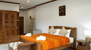 a bedroom with a bed with two towels on it at Small Hotel in Hua Hin +41 photos