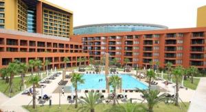 a large swimming pool in front of a building at Jeju Booyoung Hotel in Seogwipo