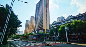 a city street with a tall building in the background at Lavande Hotel Yichang Railway East Station Branch in Yichang