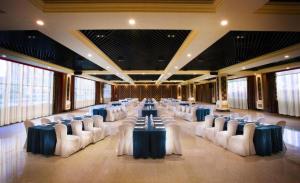 a banquet hall with tables and chairs in a room at Tongxiang Inspirock Hotel in Tongxiang +225 photos