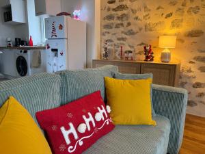 a couch with two pillows on it in a kitchen at L ancien presbytere in Avallon +14 photos