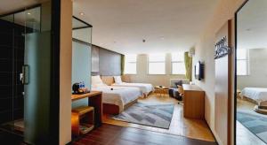 Ένα ή περισσότερα κρεβάτια σε δωμάτιο στο IU Hotel Zhengzhou Erqi Wanda Plaza Daxue Road Branch +191 φωτογραφίες