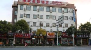a large white building with signs on the side of it at Shanghai Jiejia hotel in Shanghai
