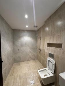 a bathroom with a toilet and a sink at روح المدينة السكنية in Medina +20 photos