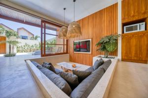 a living room with a couch and a table at Socis Del Boti Luxury Villas in Uluwatu