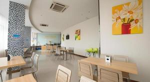 a dining room with tables and chairs in a room at City Comfort Inn Yulin Walking Street in Yulin