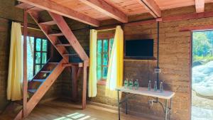 a room with a staircase and a television in a cabin at Cabañas Ticomulco in Zacatlán +114 photos