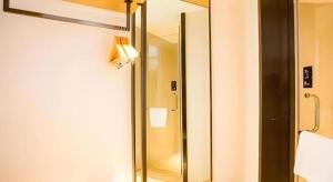 a bathroom with a shower and a mirror at City Comfort Inn Guilin Yangshuo Shili Hualang Qianguqing in Yangshuo +53 photos