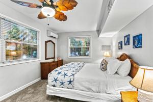 a bedroom with a bed and a ceiling fan at Mandevilla - U in Siesta Key +52 photos