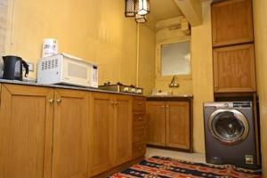 une cuisine avec un lave-linge et un micro-ondes dans l'établissement Villa Sela Gem, au Caire