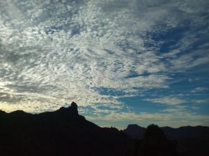 a cloudy sky with a mountain in the background at Apartamentos el Motor Tejeda in Tejeda