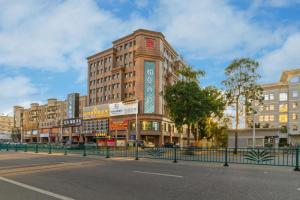 a tall building on a street in a city at Borrman Hotel Zhongshan Henglan Xiyong in Changzhou