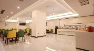 a dining room with chairs and a table in a building at Green Tree Inn Nanchang Zhongshan Road Bayiguan in Nanchang