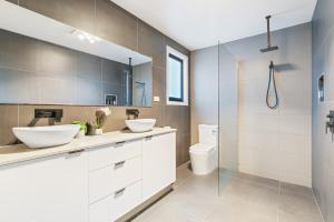 a bathroom with two sinks and a shower at Luxury Family Stay-Spacious House & Granny Retreat in Sorell +57 photos