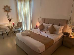 a bedroom with a large bed with a table and chairs at La Costa Hotel 15 Min from Airport,Free High-Speed WiFi, Spa Bath, Pool & Restaurant in Katunayaka +117 photos