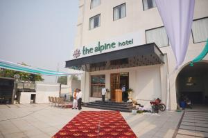 a red rug in front of a hotel at Hotel Alpine, Aligarh in Alīgarh