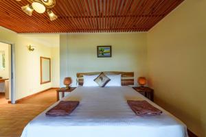 Postel nebo postele na pokoji v ubytování Mango Beach Resort