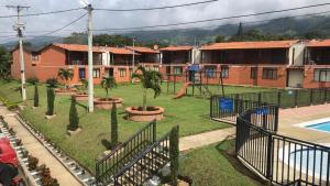 a park with a playground with a slide at Casa de descanso lago calima in Calima