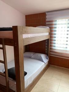 a couple of bunk beds in a room at Casa de descanso lago calima in Calima +15 photos
