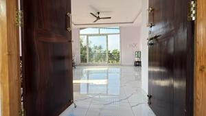 an open hallway with a tile floor and a swimming pool at Mane Malnad Farmstay in Shimoga