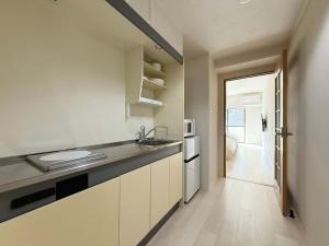 eine Küche mit Spüle und Arbeitsplatte in der Unterkunft Grandeur by b hotel - Cozy Studio in Perfect Spot Walk to Peace Park in Kami-nagarekawachō