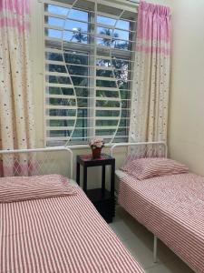 Ένα ή περισσότερα κρεβάτια σε δωμάτιο στο Magnolia homestay 2