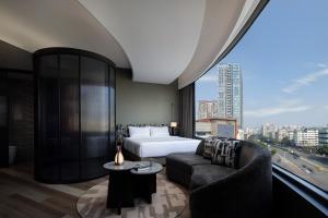 a hotel room with a bed and a large window at YOUNG Hotel Guilin -Mixc Mall in Guilin +84 photos