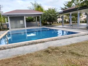 a swimming pool in a yard with a gazebo at Bali Residences in Agus