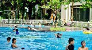 a group of people playing in a swimming pool at Alice's home Times city in Hanoi