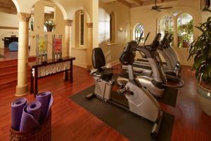 a gym with exercise bikes and a treadmill at The Mission Inn Hotel and Spa in Riverside