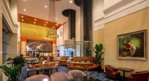 a lobby of a hotel with a bar and chairs at Qingdao Blue Horizon Hotel Huangdao in Huangdao
