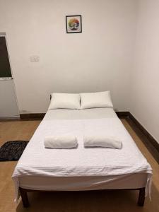 a bed in a room with two pillows on it at View 240 in Rikillagaskada