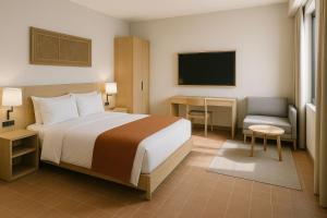 a hotel room with a bed and a television at Wenjin Culu in Elbasan