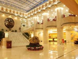 a lobby with stairs and a teddy bear in the middle at Zhangjiagang Guomao Hotel in Zhangjiagang +236 photos