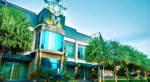 a large building with palm trees in front of it at The Loom Rangsit in Ban Lam Phak Kut
