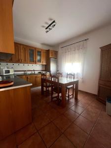 a kitchen with a table and chairs in it at El susurro del agua in Alcaudete