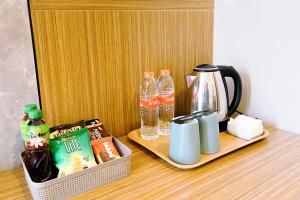 a table with a coffee maker and drinks on it at Front One Resort Indraloka Temanggung in Temanggung