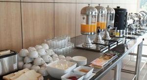 a kitchen with a counter with food and a mixer at Chaisaeng Villa in Sing Buri