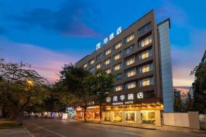 a hotel with a sign on the side of a street at Mao Hua hotel in Guangzhou