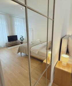 une chambre avec un lit et un miroir dans l'établissement Suites am Herzogberg, à Brunn am Gebirge