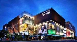 a large building with advertisements on the side of it at GreenTree Inn Shanghai National Convention and Exhibition Center Huaxiang Road in Shanghai