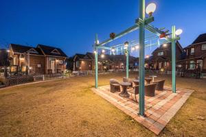 a group of benches in a park with lights at Gapyeong Haru Dog Pension in Oebang-ni