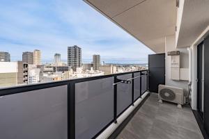 a balcony with a view of the city at Apartment Hotel 11 Nambaminami 2 in Osaka
