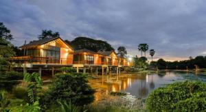 a row of houses next to a body of water at Nornnadubua in Ban Nam Tok +77 photos